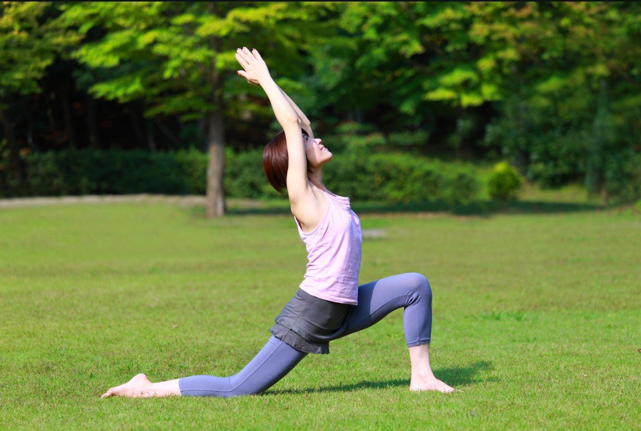 Practicing yoga by the river at dusk in Rishikesh