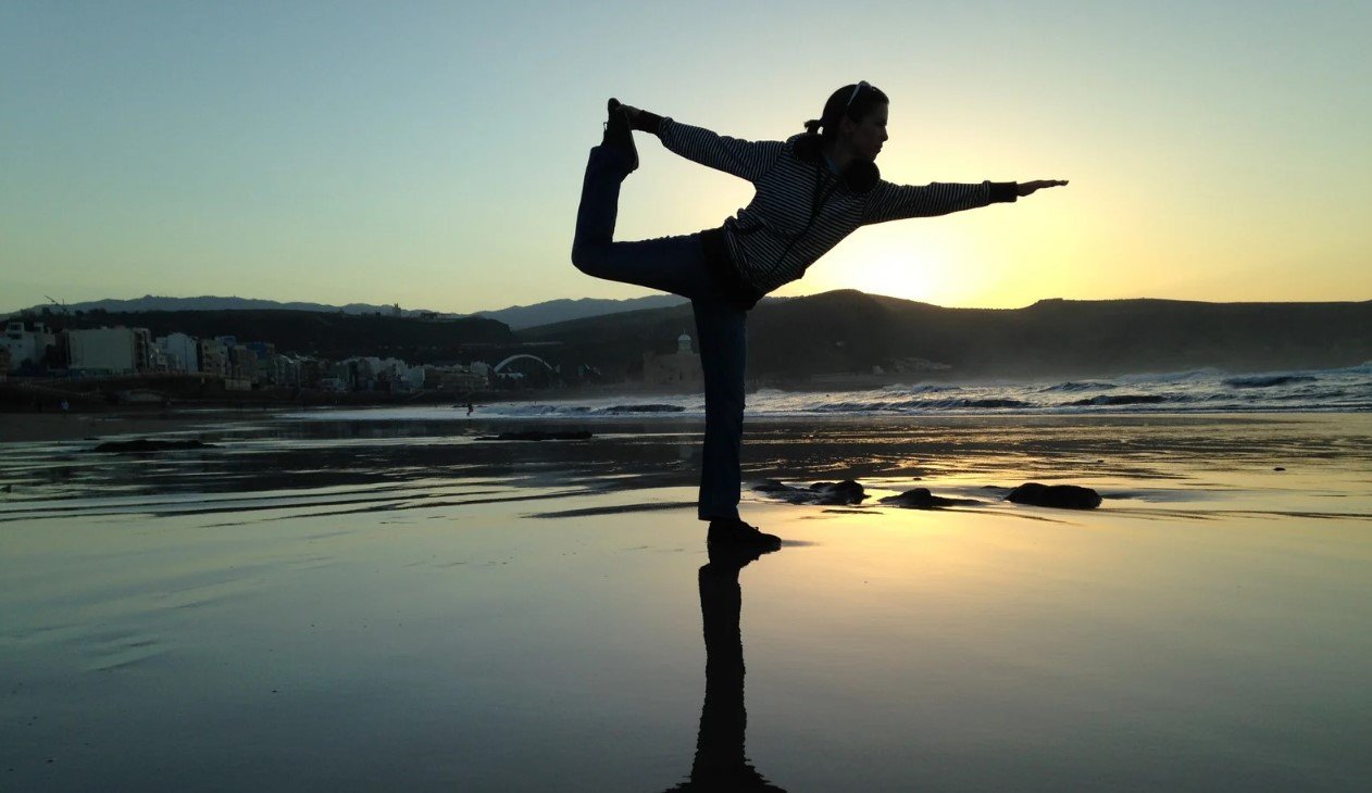 A student grounding through the feet in a standing balance pose