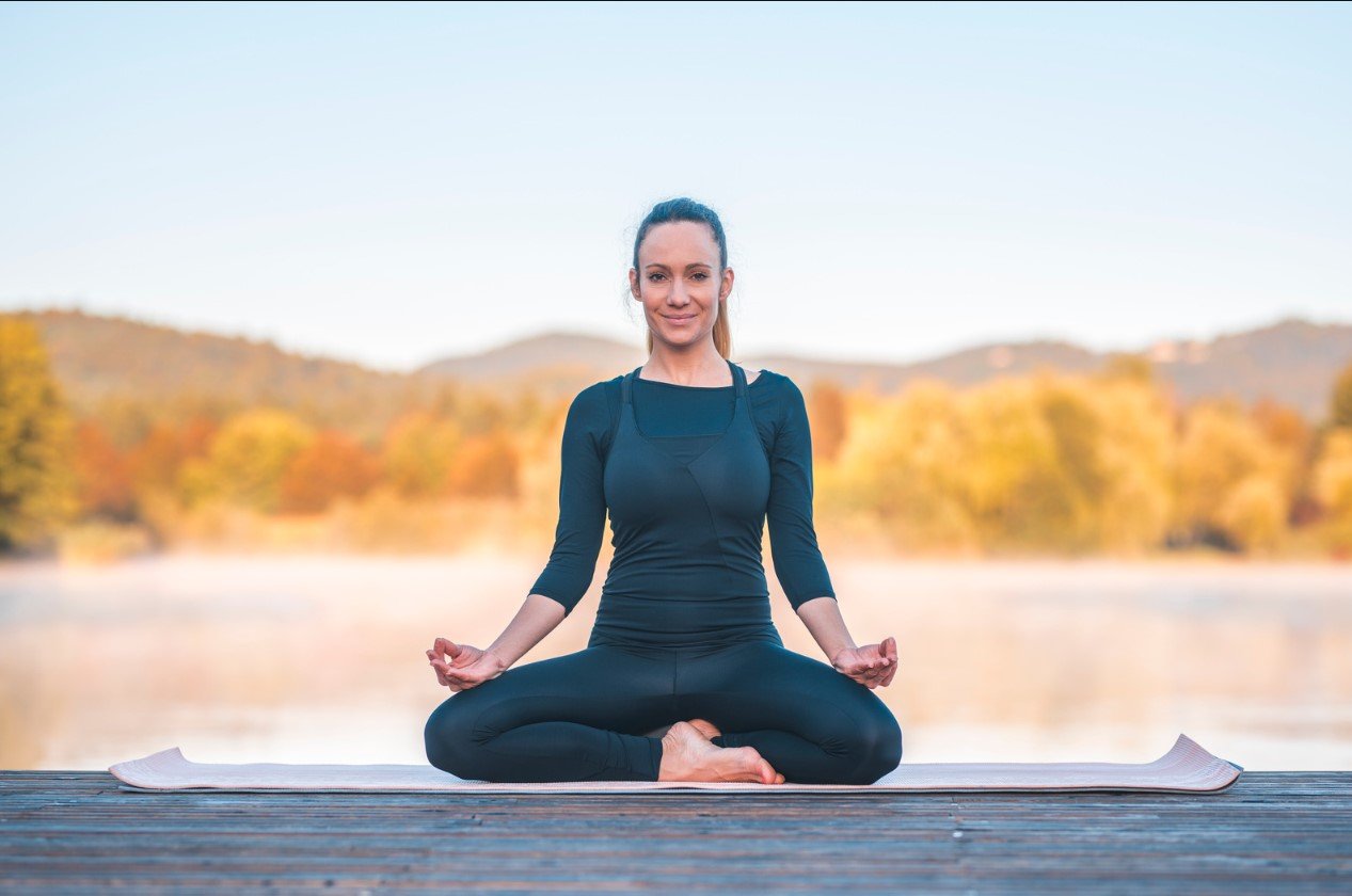 A student practicing a gentle rowing movement from the Shakti Bandha series
