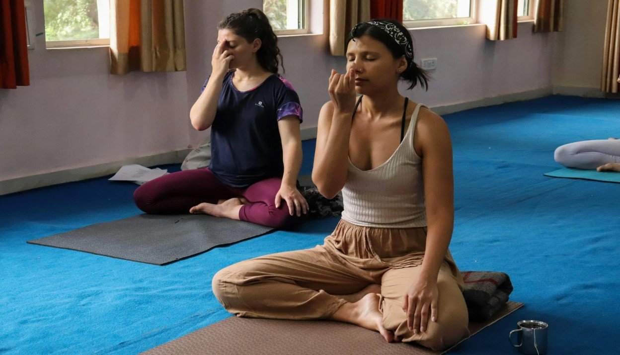 A student practicing single-nostril breathing for Surya Bheda Pranayama