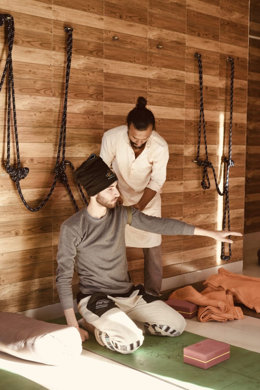 A teacher demonstrating precise alignment in a standing pose