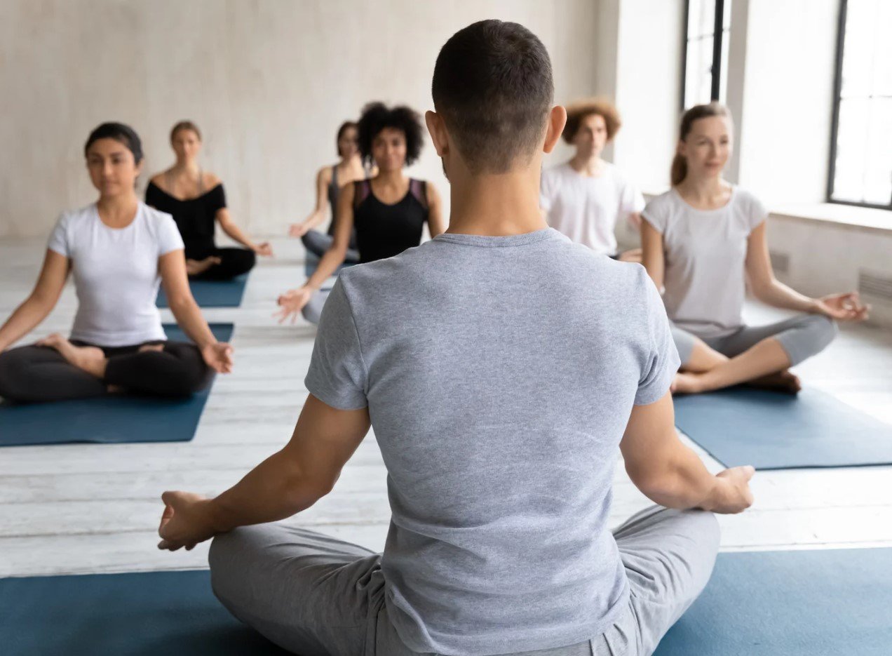 A student in a seated lotus-family pose