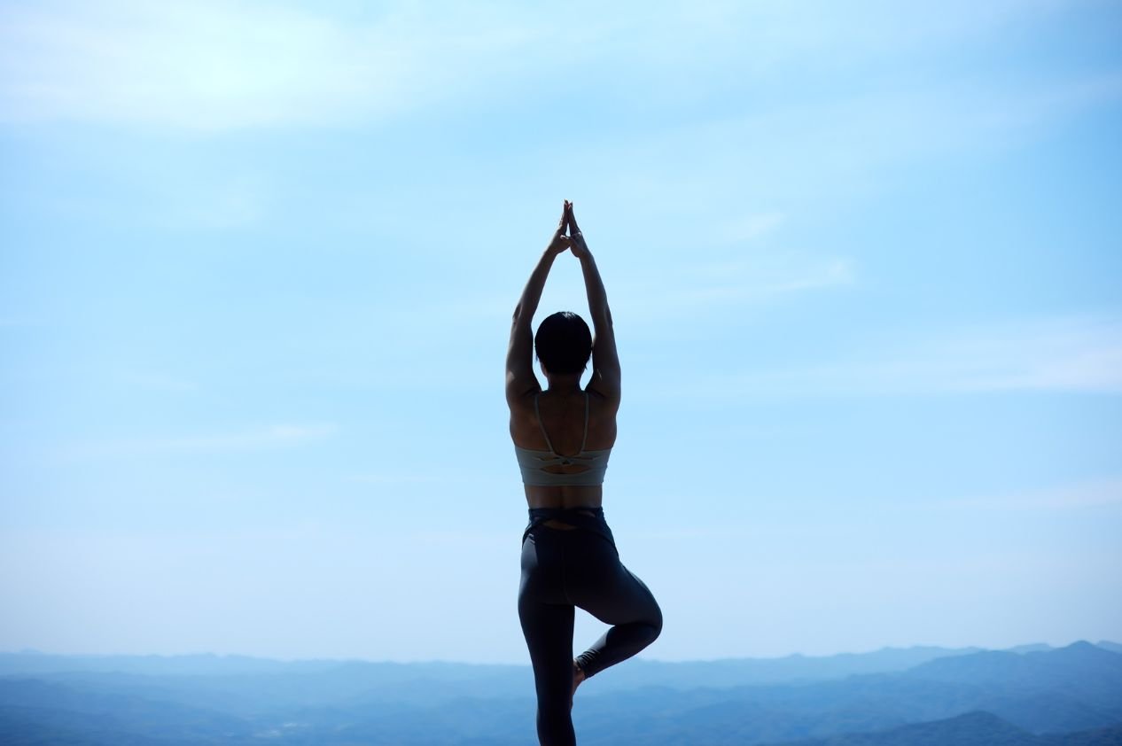 A student in Warrior II, a standing yoga pose