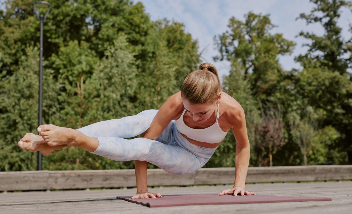 A student in deep concentration before an advanced pose