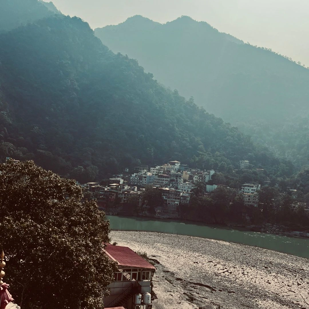 The Ganga flowing through Rishikesh with the Himalayan foothills behind